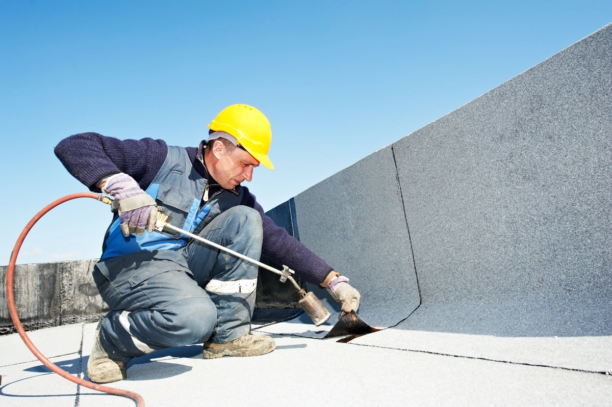 flat roofing maintenance by worker