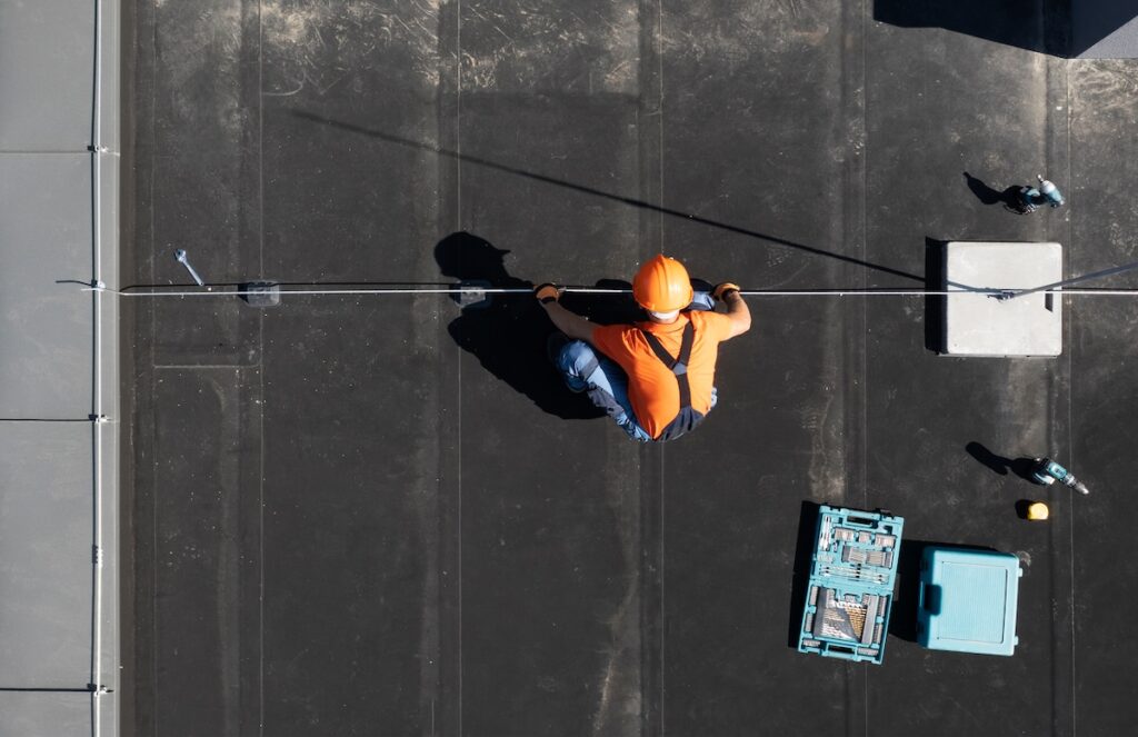 Residential Building Lightning Protection Rod Installation Performed by Professional Worker Aerial View.