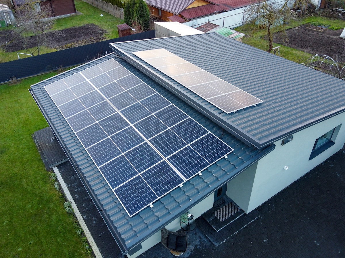 Solar panels on pitched metal roof. Home Renewable Energy Systems. Solar Rooftop System. Photovoltaic Roofing
