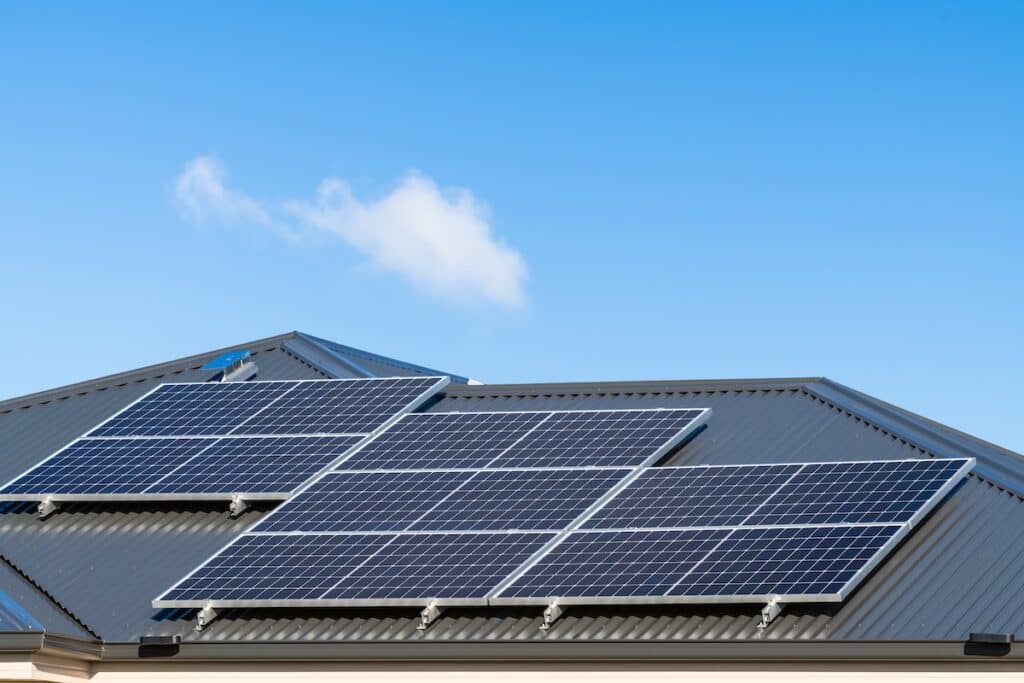 New solar panels installed on metal sheet roof of the house