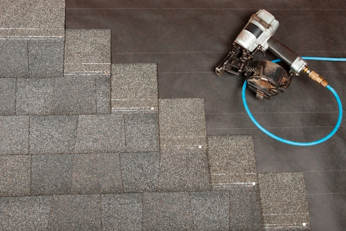 partial install of roof shingles with air nail gun