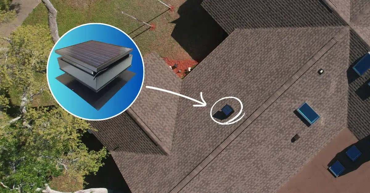A solar attic fan on a brown shingle roof.